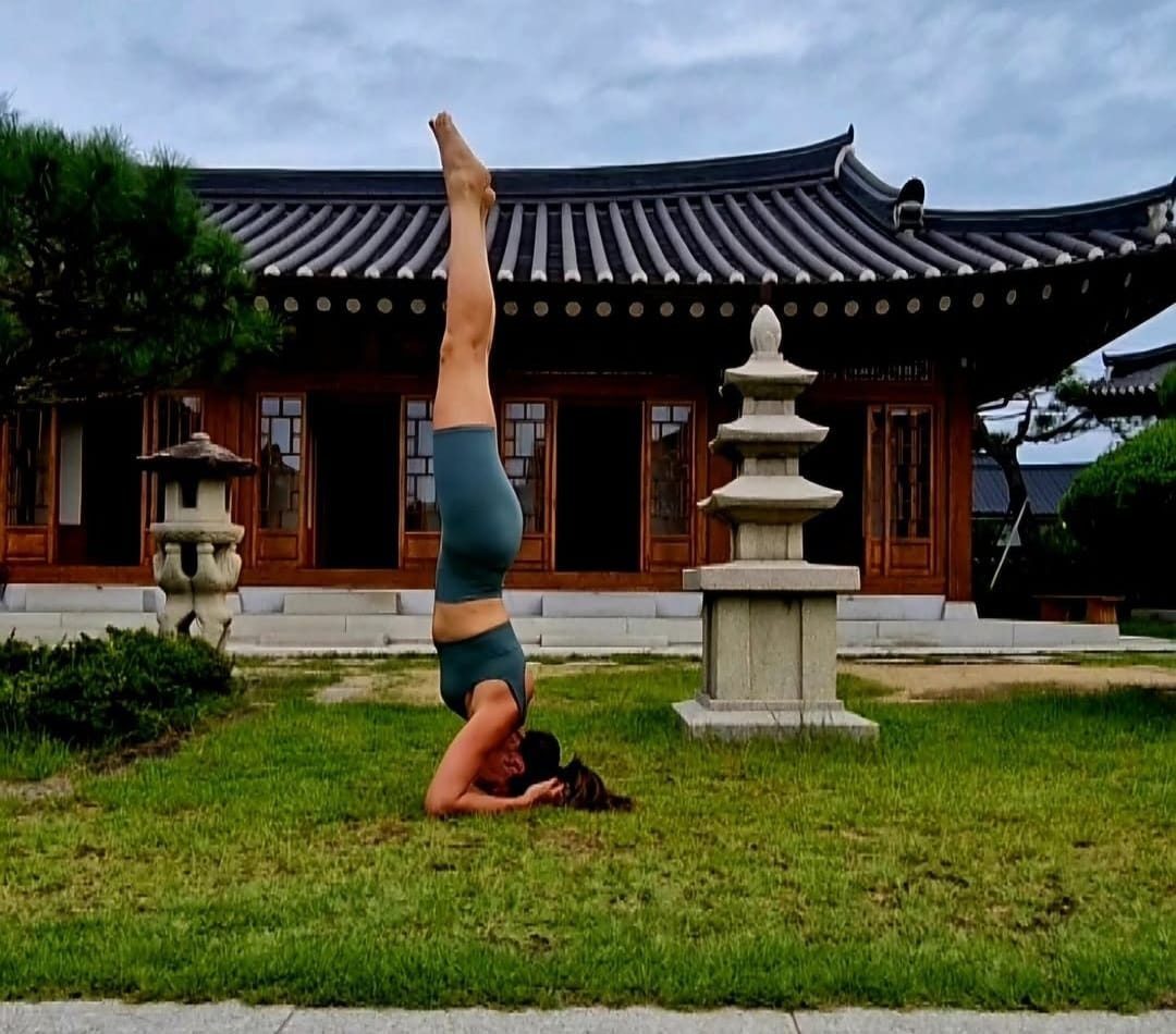 Federica Masci in headstand pose at a Korean temple